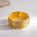 Close-up detail of gold stretch bracelet with white enamel and spiral pattern design - Square / Gold-White