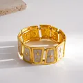 Detailed view of gold trapezoid bracelet with star motifs and white enamel. - Trapezoid / Gold-White