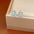 Detailed view of silver needle earrings with light blue zircon four-leaf clover design. - Blue