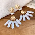 Detailed close-up of vintage baroque pearl drop earrings with textured gold-tone metal studs - Gold-White (HE33539)