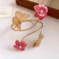Close-up of vintage gold arm cuff with pink enamel flowers and delicate butterfly detail - Dripping Oil Flower Style (HB5788) / Rose Red