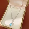 Close-up of silver necklace with blue teardrop pendant and fishtail design in box - Blue Waterdrop Fish Tail Style / Blue