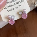 Detailed view of pink zircon flower and pearl stud earrings with S925 silver needles - Pink