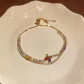 Close-up of elegant gold-plated tennis bracelet with colorful zircon flower motif - Colorful Zirconia Flower Bracelet / Gold