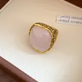 Detailed macro view of a vintage gold textured ring featuring a square pink crystal - Ring-Pink