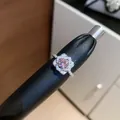 Detailed macro view of a sparkling flower-shaped open ring with pink zircon center. - Silver-Pink