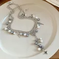 Close-up of double-layered silver chain necklace with pearls and religious medallion - Silver