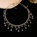 Detail macro view of an elegant vintage lace tassel choker with clear crystal drops - Silver-White