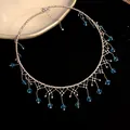 Vintage lace tassel choker with blue beads on black velvet background - Silver-Blue