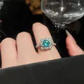Close-up of a luxury green zircon flower ring worn on a hand, featuring elegant detailing - Silver-Green