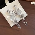 Detailed macro shot of French style resin flower earrings with silver tassel chains - Resin Wrinkled Flower Tassel (HE33052) / Clear