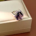 Close-up of a vintage palace style ring with pear-cut purple zircon and halo stones - Ring / Adjustable Open / Purple