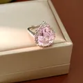 Close-up detail of an elegant pink water drop zircon ring with a polished silver finish - Ring / Adjustable Open / Pink