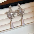 Close-up of elegant 18k gold plated flower earrings with crystal and teardrop pearls - Silver Earring Post - Silver (Real Gold Plated)