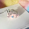 Macro detail of a cute pink enamel ear cuff featuring sparkling colorful heart-shaped gems. - Pink/Purple/Blue Mixed (Single Piece)