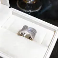 Detailed view of a silver crossover X-shaped ring set with sparkling cubic zirconia - Wide X-Shaped Style (4#) / Silver