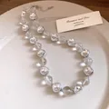 Close-up of elegant clear beaded necklace with silver crystal settings on a plate - Necklace / Silver