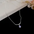Elegant silver necklace with purple zircon flower pendant and crystal-lined bar detail. - Purple