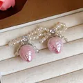Detail shot of exquisite pink strawberry pearl bow earrings with sparkling crystal - Silver Earring Post - Silver - Pink