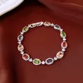 Close-up detail of multi-colored oval gemstone bracelet with sparkling halo accents - No 9 Multicolor Oval Style