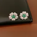 Detailed macro view of elegant flower stud earrings with green and white zircons - Stud Earrings / Silver Earring Post - Silver - Green