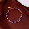 Elegant gold-tone charm bracelet featuring vibrant blue flower crystals on brown satin - No 23 Blue Six-Petal Flower Style