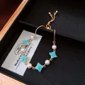 Elegant gold-tone adjustable bracelet featuring blue flower charms and white pearls - No 26 Clover Pearl Style