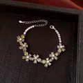 Elegant floral bracelet featuring sparkling green pear-shaped stones in a silver finish. - No 31 Green Five-Petal Flower Silver Style