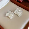 Macro detail of elegant diamond-shaped silver earrings with white mother-of-pearl chips - Wrinkled Rhombus (HE31912) / Silver & White