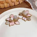 Detailed view of elegant 18K gold plated flower earrings with zircons and pearls - Flower Shape / Pink