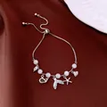 Adjustable silver bracelet with white beads and marine-themed charms on dark red satin background - No 33 Silver Ocean Theme Style