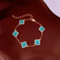 Elegant gold-tone bracelet featuring five turquoise-colored clover motifs with crystals. - No 38 Gold Blue Clover Style