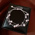 Elegant multi-strand white pearl bracelet featuring dainty silver heart charms displayed on a box - No 40 Multi-Layer Pearl Heart Style