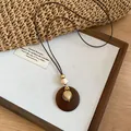 Detailed view of bohemian heart pendant necklace on minimalist display board - 5# Necklace-Coffee