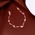 Elegant gold bracelet with pink oval and marquise gemstones on brown fabric background - No 44 Pink Oval Splicing Style