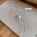 Detail of silver adjustable necklace with hollow zircon flower pendant on grey background - Hollow Flower Style / Silver