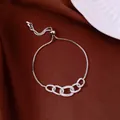 Adjustable silver bracelet featuring five interlocking pavé crystal oval links on brown silk. - No 59 Five Interlocking Ring Zirconia Style