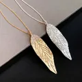 Elegant leaf pendant necklaces in gold and silver with sparkling stone accents - Necklace / Gold/Silver