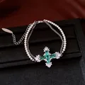 Detailed view of a double-layered pearl and zircon bracelet with a green cross pendant - Bracelet / Silver-Green