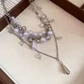 Close-up view of French multi-layer pearl necklace with silver beads and drop pendant. - Silver