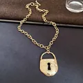 Close-up of vintage gold chunky chain necklace with oversized lock pendant detail - Lock Shape / Gold