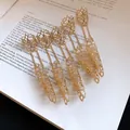 Detailed macro view of gold Gothic hollow finger armor rings featuring delicate chain linkage - Finger Armor Ring (HR3460) / Gold