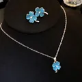 Detailed view of blue cat-eye stone four-leaf clover necklace and earring jewelry set - Necklace and Earrings Set / Blue