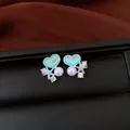 Close-up detail of silver needle stud earrings featuring blue heart enamel and a pearl - Style 3 Heart & Starfish