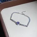 Close-up of vintage silver bracelet with sparkling zircons and purple center stone - Silver Purple