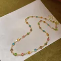 Detailed close-up of a dainty gold-tone necklace featuring colorful round resin charms. - Gold-Multicolor