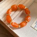 Detail view of orange irregular acrylic bead bracelet in a jewelry tray - Orange