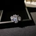Macro detail of a luxurious zircon hollow flower ring with a rectangular centerpiece - Rectangular Stone Flower Style (Silver)