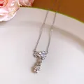Detailed view of silver stainless steel necklace with cute rabbit and flower pendant. - Silver
