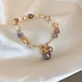 Macro view of multi-colored freshwater pearl bracelet with lucky cat charm on satin - 7# Gold Multi-color Pearl with Lucky Cat Charm